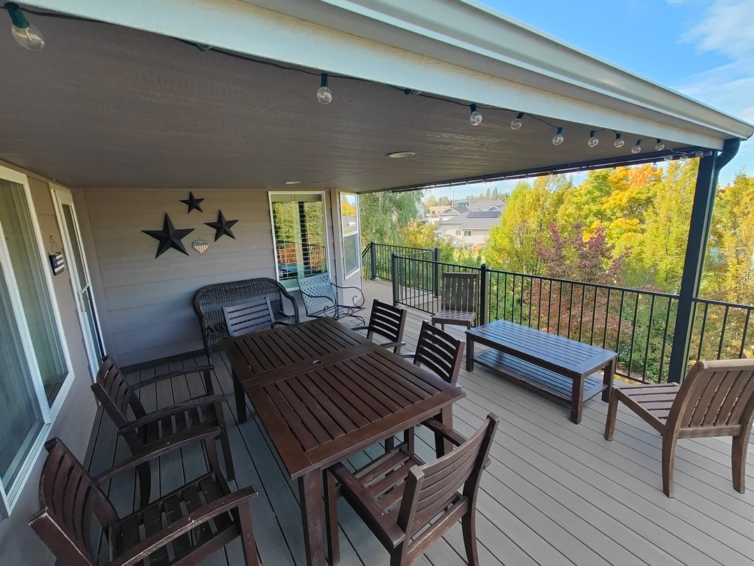 Finished furnished deck with covered dining and open seating areas