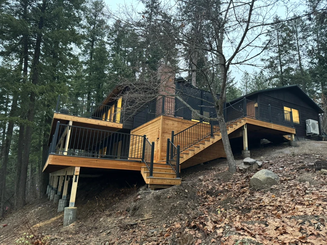 Elevated deck showing pier footings, framing, stairs, railing, and fascia